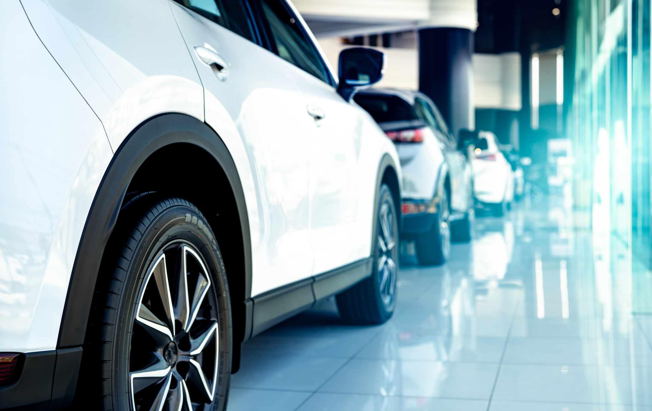 Test driving a car at a dealership, part of the process of buying a new car