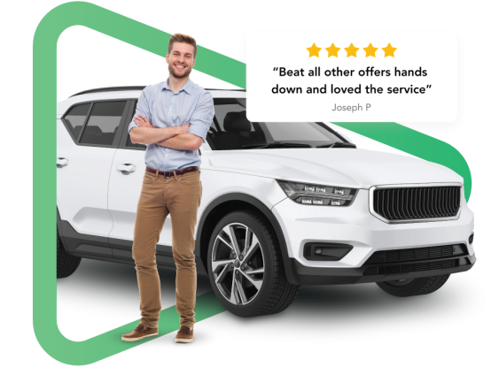 White man with brown hair standing with crossed arms in front of a white SUV car